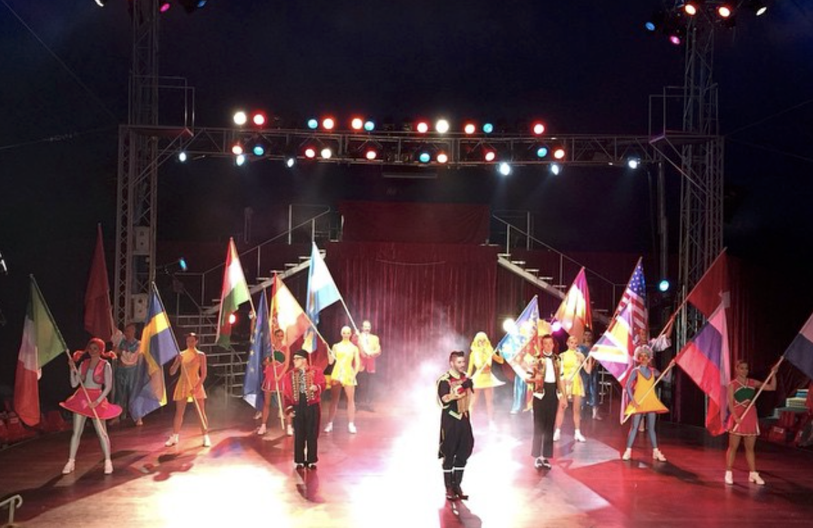 benidorm circus act holding flags of the world
