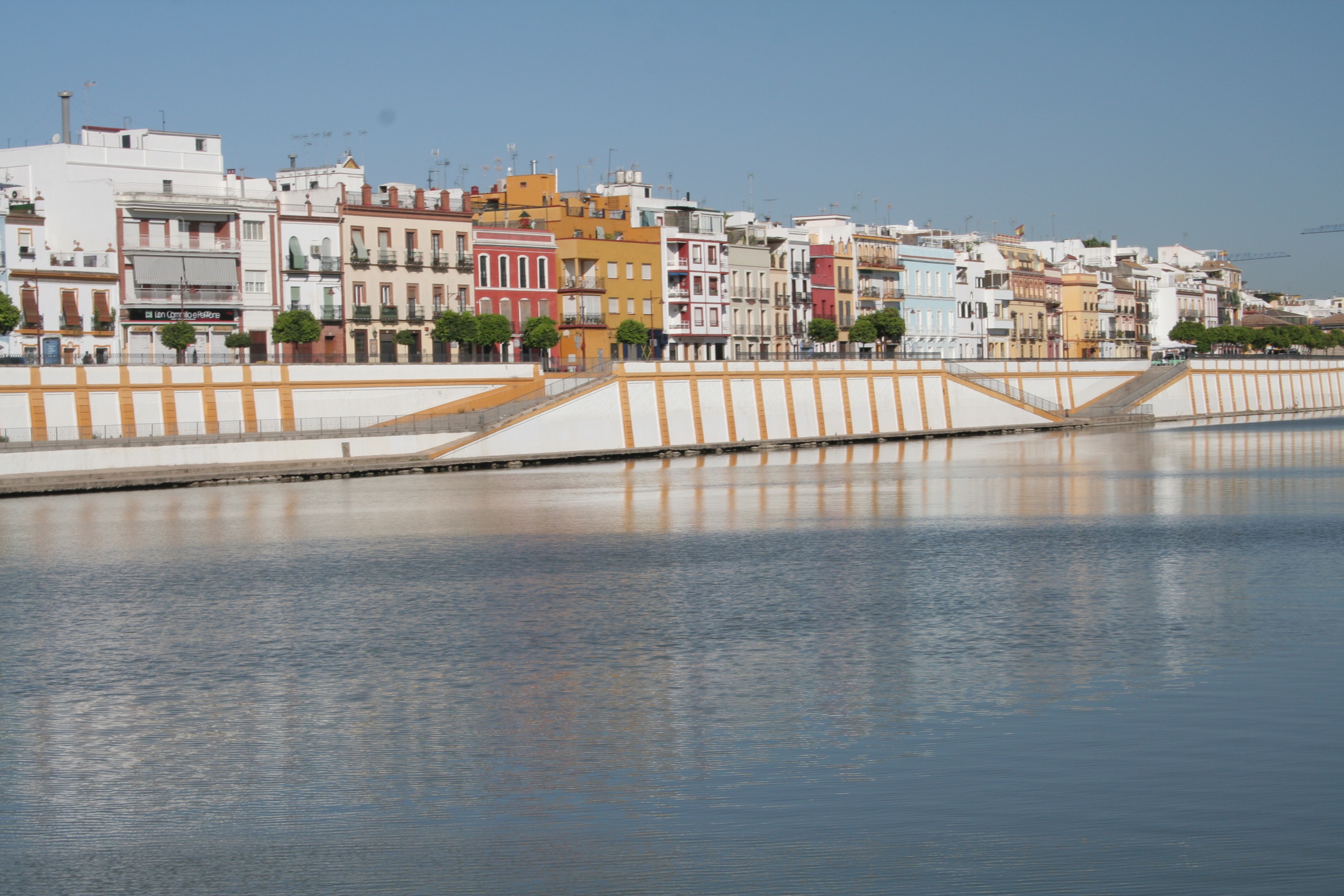 coloured houses lining the river in seville spain