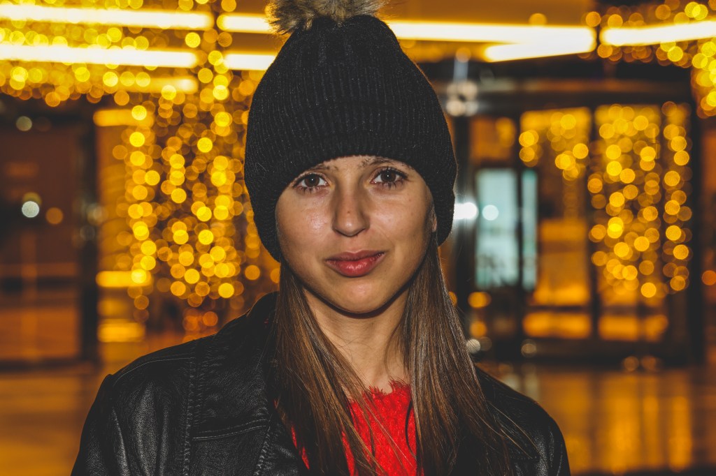 Girl looking forward Christmas lights behind at Alicante  