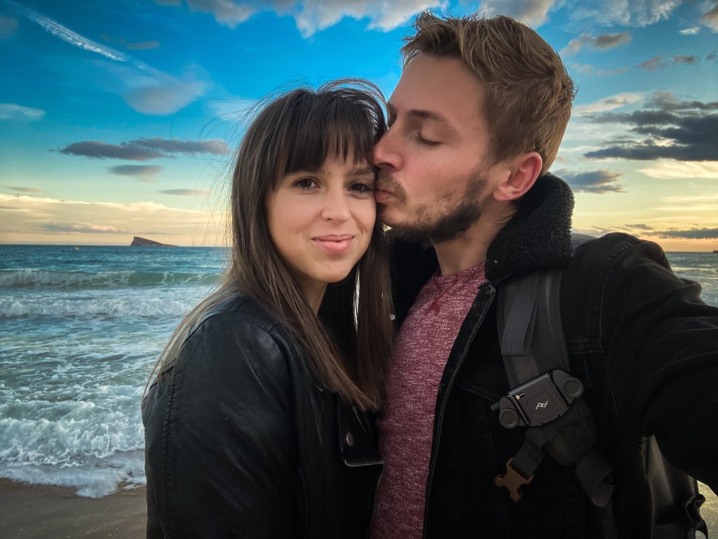 Boy kissing girl at sunset Benidorm 