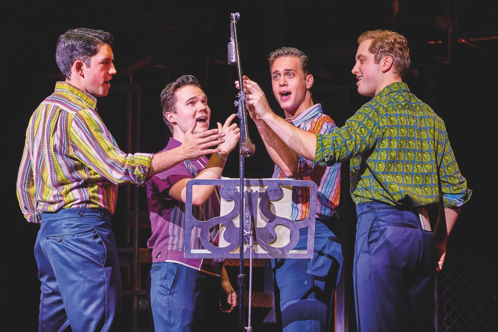 Left or right Christopher short Ryan Heenan Blair Gibson Dalton wood in Jersey boys wearing relaxed colourful shirts and blue trousers￼ singing into an old mic￼